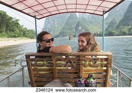 A Mother And Daughter Riding A Boat Down Li River; Guilin, Guangxi, China View Large Photo Image Picture - A Mother And Daughter Riding A Boat Down Li River; Guilin, Guangxi, China. Fotosearch