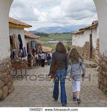 Stock Image - A Mother And Daughter Walk Through The Street; Chinchero Peru. Fotosearch
