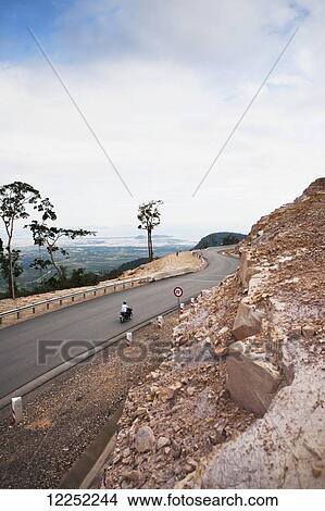 Picture - A motorbike ride to the top of Bokor Hill station, Preah Monivong National Park; Cambodia. Fotosearch