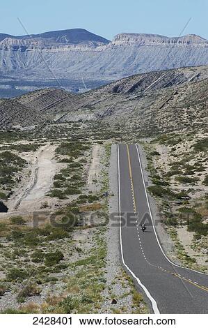 A motorcycle travels on route 40 with rugged mountains in the distance; Neuquen Province, Argentina View Large Photo Image Stock Image - A motorcycle travels on route 40 with rugged mountains in the distance; Neuquen Province, Argentina. Fotosearch