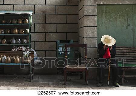 Stock Photo - A muslim old man sleep close to the tibetan musk from Barkhor neighbourhood; Lhasa, Tibet, China. Fotosearch