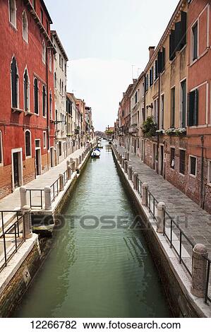 A narrow canal lined with residential buildings; Venice, Italy View Large Photo Image Stock Image - A narrow canal lined with residential buildings; Venice, Italy. Fotosearch