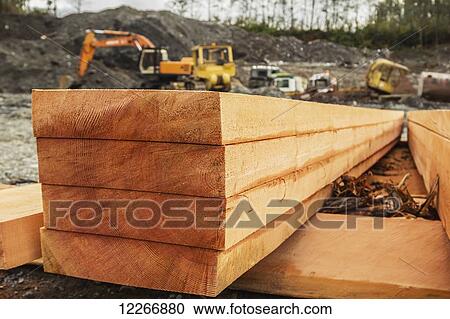 A neat stack of fresh lumber is shown on a side profile revealing the raw grain of the log and texture in the lumber planks ready for construction; Port McNeill, British Columbia, Canada View Large Photo Image Stock Image - A neat stack of fresh lumber is shown on a side profile revealing the raw grain of the log and texture in the lumber planks ready for construction; Port McNeill, British Columbia, Canada. Fotosearch