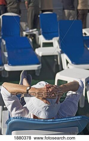 Stock Photo - A Passenger Sitting And Relaxing On The Sun Deck Of Cruise Ship. Fotosearch