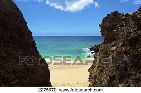 A person jumping off the rugged rocks on the coast of an hawaiian island; Hawaii, United States of America View Large Photo Image Stock Image - A person jumping off the rugged rocks on the coast of an hawaiian island; Hawaii, United States of America. Fotosearch