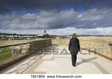 A Person On A Walkway Alone From Behind View Large Photo Image Picture - A Person On A Walkway Alone From Behind. Fotosearch
