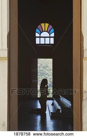 Stock Photo - A Person Praying In The El Cobre Church.. Fotosearch
