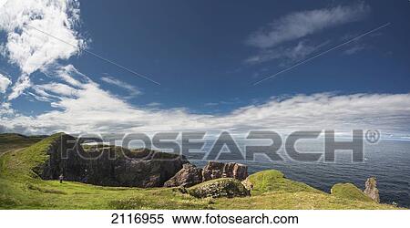 Stock Photography - A Person Stands Looking At The Rocky Promontory At St Abb's Head; Scottish Borders Scotland. Fotosearch