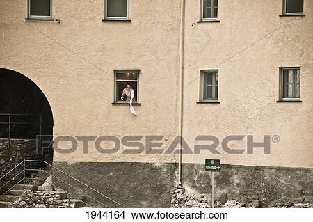 Picture - A Person Stands Looking Out Their Window; San Frutuozzo Liguria Italy. Fotosearch