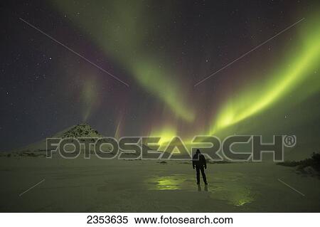 A Person Stands On The Frozen Blackstone River Beneath The Northern Lights; Yukon, Canada View Large Photo Image Stock Photography - A Person Stands On The Frozen Blackstone River Beneath The Northern Lights; Yukon, Canada. Fotosearch
