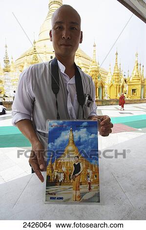 A photographer with a posed souvenir portrait at the Shwedagon Pagoda; Rangoon, Burma View Large Photo Image Picture - A photographer with a posed souvenir portrait at the Shwedagon Pagoda; Rangoon, Burma. Fotosearch
