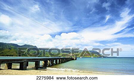 A pier leading out from the beach to a covered structure; Hawaii, United States of America View Large Photo Image Picture - A pier leading out from the beach to a covered structure; Hawaii, United States of America. Fotosearch
