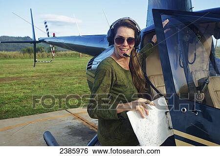 A pilot prepares a helicopter for flight; Kilauea, Hawaii, United States of America View Large Photo Image Stock Photograph - A pilot prepares a helicopter for flight; Kilauea, Hawaii, United States of America. Fotosearch