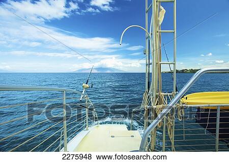 A platform and lifeboat on a boat with a view of the coastline of an hawaiian island; Hawaii, United States of America View Large Photo Image Stock Photo - A platform and lifeboat on a boat with a view of the coastline of an hawaiian island; Hawaii, United States of America. Fotosearch