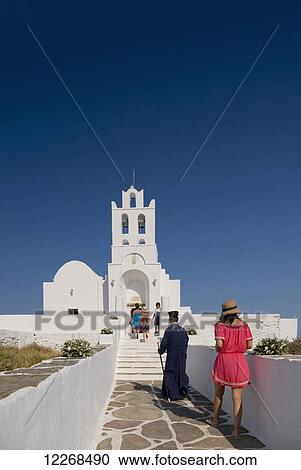 Stock Image - A priest arriving for a wedding at the Chrysopiyi Monastery; Sifnos, Cyclades, Greek Islands, Greece. Fotosearch