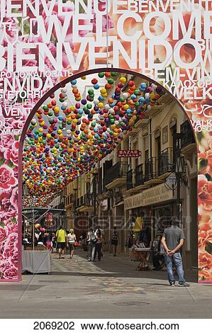 A Promenade Between The Shops Decorated By A Canopy Of Colourful Paper Balloons; Ronda Malaga Spain View Large Photo Image Stock Image - A Promenade Between The Shops Decorated By A Canopy Of Colourful Paper Balloons; Ronda Malaga Spain. Fotosearch