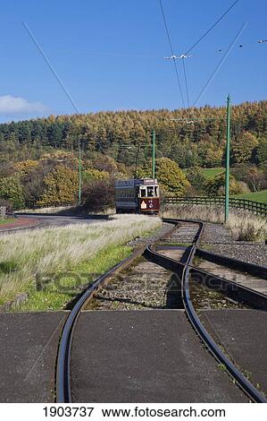 A Rail Car Travels Down The Tracks; Beamish, Durham, England View Large Photo Image Stock Photo - A Rail Car Travels Down The Tracks; Beamish, Durham, England. Fotosearch