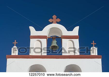 Stock Image - A red and white painted bell tower on a church; Oia, Santorini, Cyclades, Greek Islands, Greece. Fotosearch