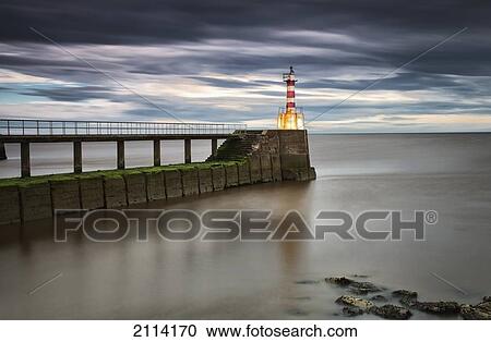 A Red And White Striped Lighthouse At The End Of A Pier; Amble Northumberland England View Large Photo Image Stock Image - A Red And White Striped Lighthouse At The End Of A Pier; Amble Northumberland England. Fotosearch