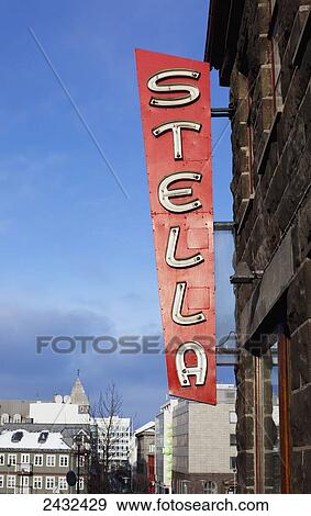 Stock Photo - A red neon sign Stella mounted on the side of a building; Reykjavik, Iceland. Fotosearch