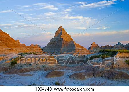 Stock Image - A Red Sunrise Illuminates The Hills In Badlands National Park; South Dakota United States Of America. Fotosearch