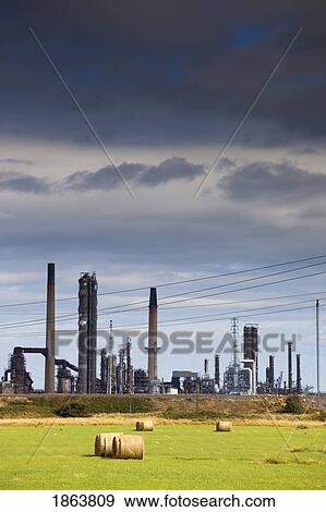 A Refinery With Hay Bales In The Foreground View Large Photo Image Stock Photo - A Refinery With Hay Bales In The Foreground. Fotosearch
