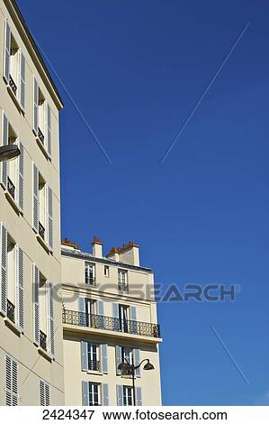 A residential building and a blue sky; Paris, France View Large Photo Image Stock Photo - A residential building and a blue sky; Paris, France. Fotosearch