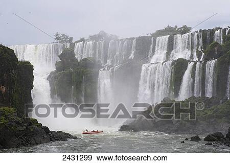 Stock Photo - A RIB boat takes tourists to see the waterfalls at Iguacu National Park; Brazil. Fotosearch