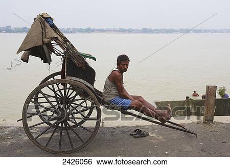 A rickshaw driver on the riverbank; Kolkata, India View Large Photo Image Stock Photograph - A rickshaw driver on the riverbank; Kolkata, India. Fotosearch