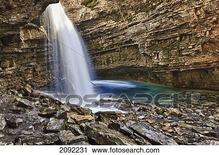 Stock Image - A River Cascades Over A Small Waterfall In Johnston Canyon In Banff National Park; Banff Alberta Canada. Fotosearch