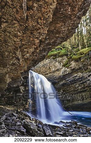Stock Photo - A River Cascades Over A Small Waterfall In Johnston Canyon In Banff National Park; Banff Alberta Canada. Fotosearch