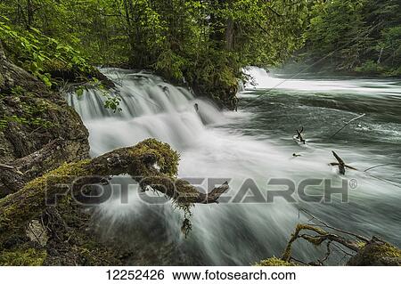 A river flows over a small waterfall in Nisga'a Memorial Lava Bed Provincial Park; British columbia, Canada View Large Photo Image Stock Photograph - A river flows over a small waterfall in Nisga'a Memorial Lava Bed Provincial Park; British columbia, Canada. Fotosearch