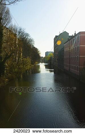 A river lined with trees on one side and buildings on the other; Hamburg, Germany View Large Photo Image Stock Image - A river lined with trees on one side and buildings on the other; Hamburg, Germany. Fotosearch