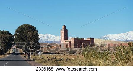 A Road Going By A Temple With Blue Sky And The Atlas Mountains; Souss-Massa-Draa, Morocco View Large Photo Image Stock Photo - A Road Going By A Temple With Blue Sky And The Atlas Mountains; Souss-Massa-Draa, Morocco. Fotosearch