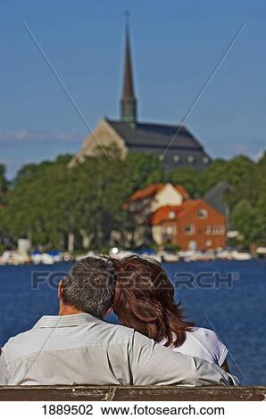 Stock Image - A Romantic Couple Enjoy The View Of The Small Town Of Vadstena.. Fotosearch