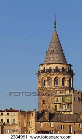 A round tower with peak and spire against a blue sky and residential buildings in the foreground; Istanbul, Turkey View Large Photo Image Stock Image - A round tower with peak and spire against a blue sky and residential buildings in the foreground; Istanbul, Turkey. Fotosearch