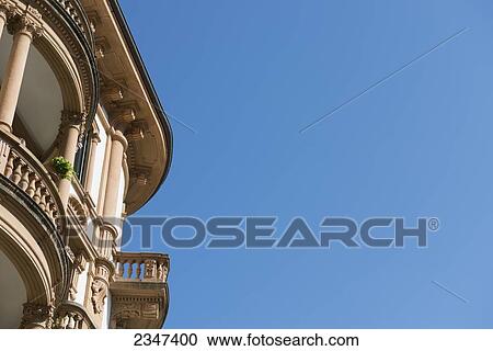 Stock Image - A Rounded Balcony On A Building Against A Blue Sky; Locarno, Ticino, Switzerland. Fotosearch