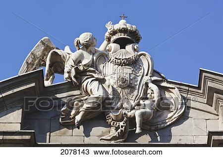 A Royal Shield On The Alcala Gate Supported By Fame With The Aid Of A Child; Madrid Spain View Large Photo Image Stock Image - A Royal Shield On The Alcala Gate Supported By Fame With The Aid Of A Child; Madrid Spain. Fotosearch