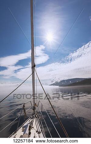 A sailboat journeys on Johnstone Strait along the coast; British Columbia, Canada View Large Photo Image Picture - A sailboat journeys on Johnstone Strait along the coast; British Columbia, Canada. Fotosearch