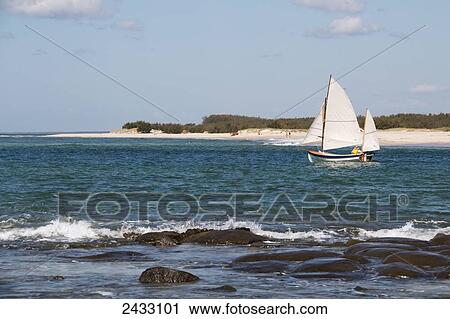 A sailboat off the coast with white sand beach and blue sky; Caloundra, Queensland, Australia View Large Photo Image Stock Image - A sailboat off the coast with white sand beach and blue sky; Caloundra, Queensland, Australia. Fotosearch