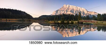 A Scenic Shot Of A Mountainside And Small Bridge; Banff National Park, Alberta, Canada View Large Photo Image Stock Image - A Scenic Shot Of A Mountainside And Small Bridge; Banff National Park, Alberta, Canada. Fotosearch