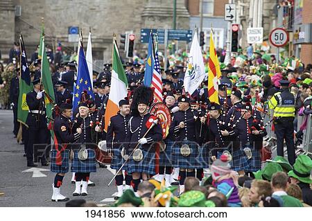 Stock Photograph - A Scottish Group Wearing Kilts And Carrying Flags For The Saint Patrick's Day Parade; Dublin Ireland. Fotosearch