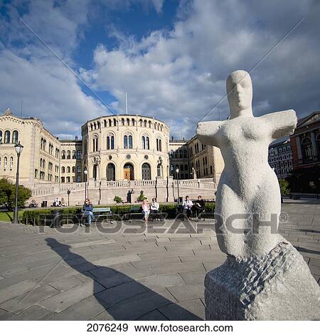 Stock Photo - A Sculpture And Norwegian Parliament Building; Oslo Norway. Fotosearch