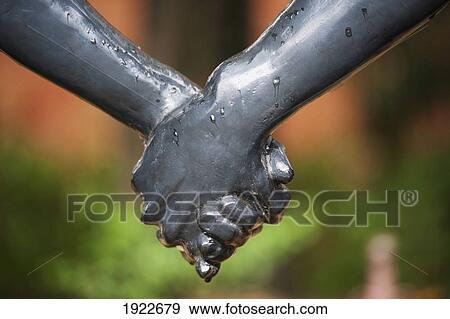Stock Photo - A Sculpture Of Holding Hands In The Peace Park; Nagasaki, Japan. Fotosearch