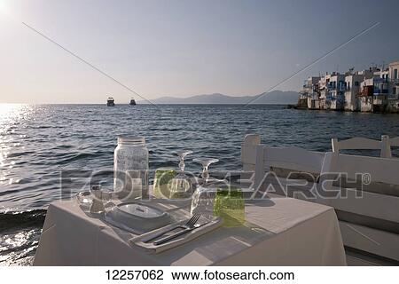 A seafront table set for dinner in the Little Venice area; Mykonos Town, Mykonos, Cyclades, Greek Islands, Greece View Large Photo Image Stock Image - A seafront table set for dinner in the Little Venice area; Mykonos Town, Mykonos, Cyclades, Greek Islands, Greece. Fotosearch