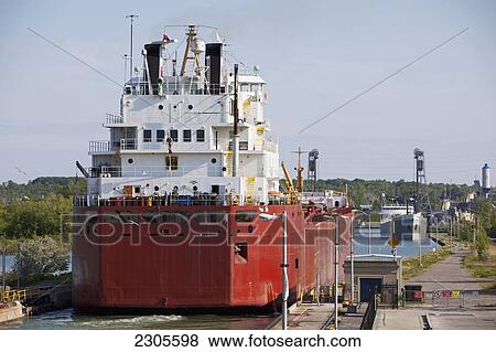 Stock Photo - A Self-Unloading Bulk Freighter And A Cement Carrier At Lock 3 Of The Welland Canal; St. Catharines Ontario Canada. Fotosearch