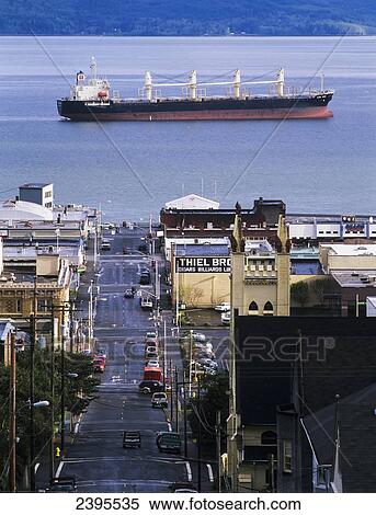 Stock Photography - A ship anchors off the Astoria Riverfront; Astoria, Oregon, United States of America. Fotosearch