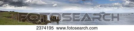 Stock Photography - A ship and boats in the water along the coastline; South Shields, Tyne and Wear, England. Fotosearch