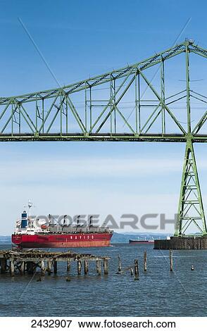 Stock Photo - A ship goes up the Columbia River; Astoria, Oregon, United States of America. Fotosearch