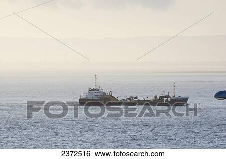 Stock Photograph - A ship in the water with fog; Bristol, England. Fotosearch